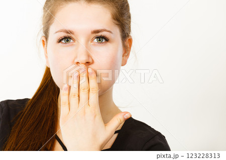 Woman covering her mouth with hand Woman covering her mouth with hand 123228313