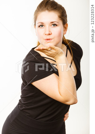 Portrait of happy attractive woman sending air kiss 123228314