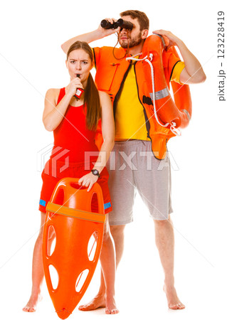 Lifeguards in life vest with ring buoy whistling. Lifeguards in life vest with ring buoy whistling. 123228419
