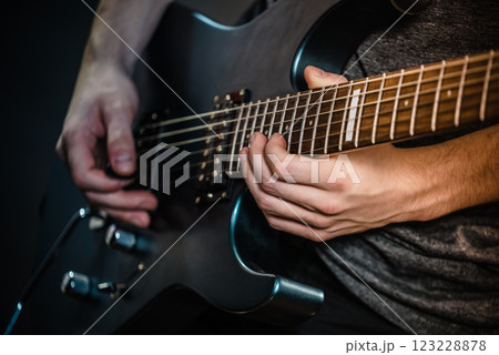 Male hands playing electric guitar Male hands playing electric guitar 123228878