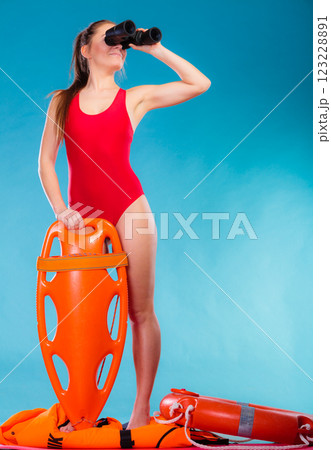 lifeguard on duty looking through binocular 123228891