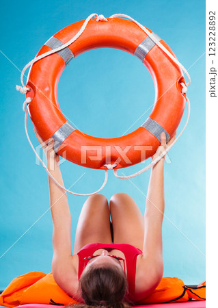 Woman holding life buoy ring Woman holding life buoy ring 123228892