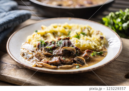 Roasted Pork Neck with mashed potatoes and mushroom sauce on a plate Roasted Pork Neck with mashed potatoes and mushroom sauce on a plate 123229357
