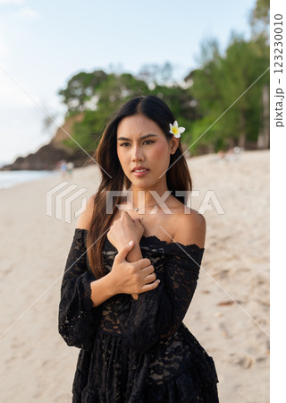 Beautiful young Asian woman during summer beach holiday 123230010