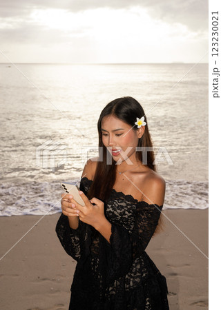 Portrait of beautiful young Asian woman during summer beach holiday 123230021