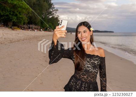 Portrait of beautiful young Asian woman during summer beach holiday 123230027