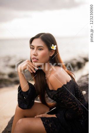 Beautiful young Asian woman during summer beach holiday 123230060