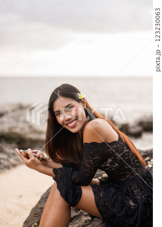 Beautiful young Asian woman during summer beach holiday 123230063