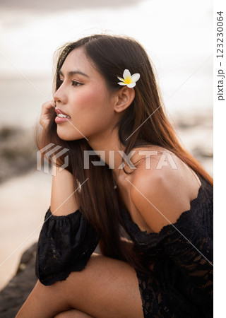 Beautiful young Asian woman during summer beach holiday 123230064