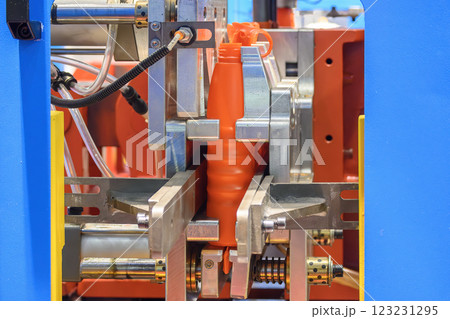 The motor oil bottle manufacturing process by blow mold machine. 123231295