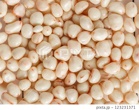 Dried fruits in white milk chocolate. Background, texture, lots of candy. 123231371