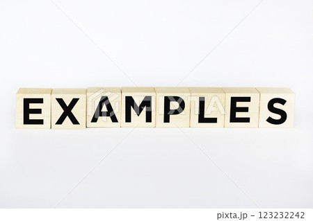 The symbol of the examples. The conceptual word "examples" on wooden blocks on a white background.  123232242