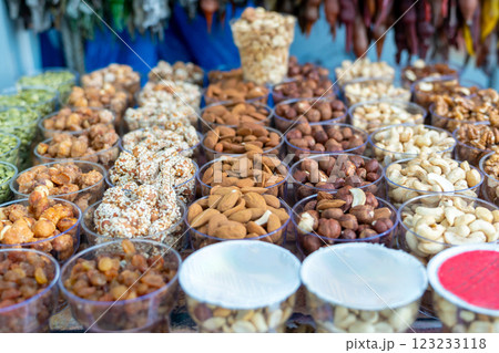 A variety of nuts at a street market in plastic containers A variety of nuts at a street market in plastic containers 123233118