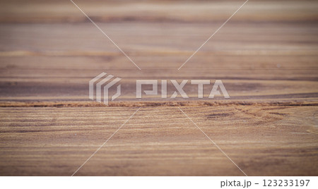 Close-up of a rustic wooden table with a blurred natural background 123233197