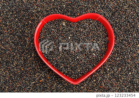 black quinoa in ceramic bowl as a background. Top view. Flat lay 123233454