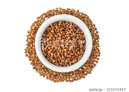 Raw buckwheat in ceramic bowl isolated on white background. Top view. Flat lay Raw buckwheat in ceramic bowl isolated on white background. Top view. Flat lay 123233457