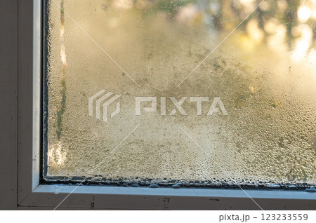 drops of water run down the windowpane. condensate drops of water run down the windowpane. condensate 123233559