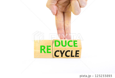 Reduce or recycle symbol. Concept words Reduce Recycle on wooden block. Beautiful white table white background. Businessman hand. Business reduce or recycle concept. Copy space. Reduce or recycle symbol. Concept words Reduce Recycle on wooden block. Beautiful white table white background. Businessman hand. Business reduce or recycle concept. Copy space. 123233893