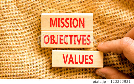 Mission objectives values symbol. Concept words Mission Objectives Values on beautiful blocks. Beautiful canvas background. Businessman hand. Business mission objectives values concept. Copy space. Mission objectives values symbol. Concept words Mission Objectives Values on beautiful blocks. Beautiful canvas background. Businessman hand. Business mission objectives values concept. Copy space. 123233921