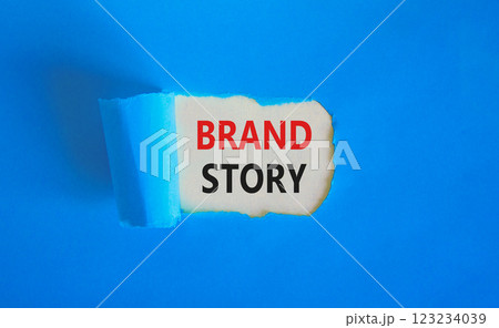 Brand story branding symbol. Concept words Brand story on beautiful white paper. Beautiful blue paper background. Business brand story branding concept. Copy space. Brand story branding symbol. Concept words Brand story on beautiful white paper. Beautiful blue paper background. Business brand story branding concept. Copy space. 123234039