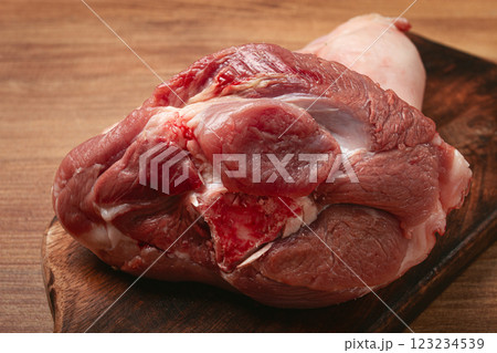 Raw pork knuckle, on a wooden chopping board, close-up, top view, no people, 123234539