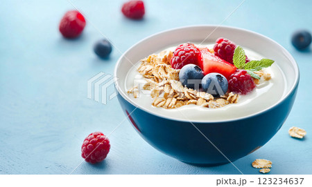 delicious yogurt with blueberries and raspberries on a blue background 123234637