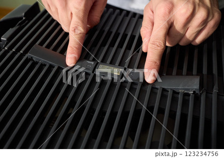 Hands adjusting a modern appliances control panel for optimal functionality and home comfort 123234756