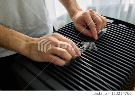 Hands adjusting a modern appliances control panel for optimal functionality and home comfort 123234760
