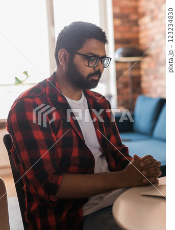 Sad indian man freelancer or entrepreneur have video conference talking, working remotely online at home office copy space - video call and diversity concept 123234830
