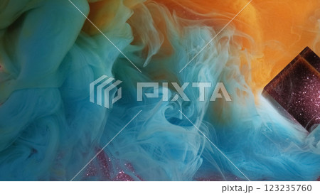 Multicolored smoke. Bright fume. Blue orange blur stream haze paint spreads on glitter abstract background. Shining glass cube in water. Multicolored smoke. Bright fume. Blue orange blur stream haze paint spreads on glitter abstract background. Shining glass cube in water. 123235760