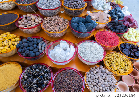 Traditional spices market. Pots and wooden tubs stand in row with colorful tea, spices, fruits, roots, flowers. Street bazaar. Dubai, UAE.  123236184