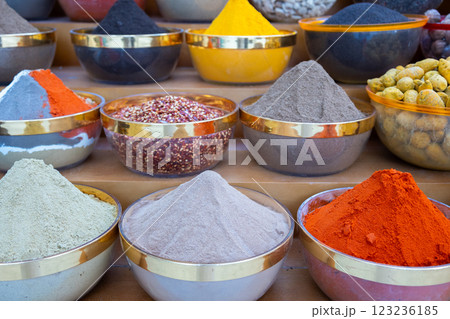 Traditional spices market. Pots and wooden tubs stand in row with colorful tea, spices, fruits, roots, flowers. Street bazaar. Dubai, UAE.  123236185