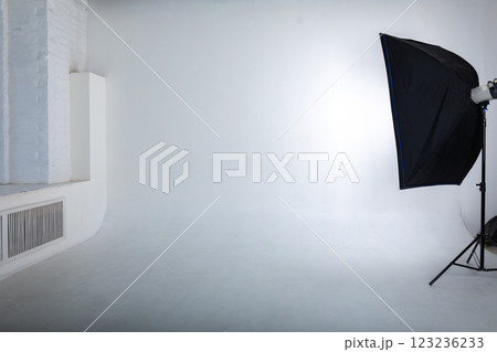 Clear white cyclorama. Light background with with professional lighting equipment. Plain wall empty photo studio 123236233