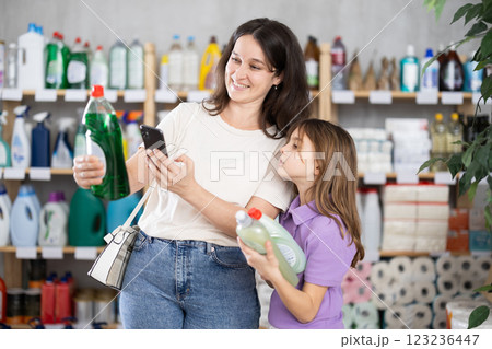 Woman with child scanning barcode of detergent packaging 123236447