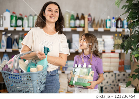 Woman and girl buyers with filled basket purchases wanders around store, looking at display cases 123236454