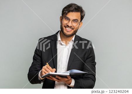 Business man making notes writing down thoughts with pen into notepad notebook diary, good idea Business man making notes writing down thoughts with pen into notepad notebook diary, good idea 123240204