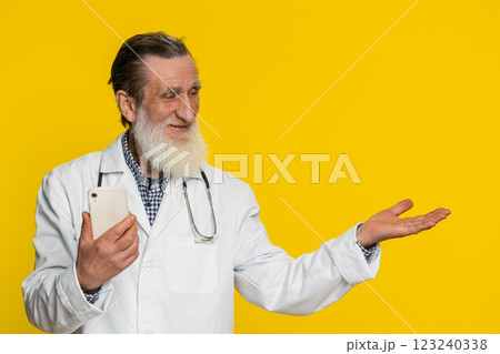 Doctor man using smartphone show point empty place, advertising application area, positive feedback Doctor man using smartphone show point empty place, advertising application area, positive feedback 123240338