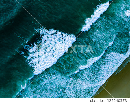 Overhead view to blue stormy ocean waves with white foam in the ocean,Sea water with splashes and foam, Top view waves background, Natural background photo sea texture with waves soft focus 123240378