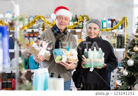 Elderly couple shopping for Christmas presents together at goods store 123241251