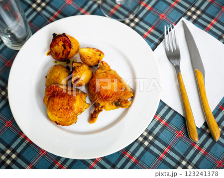 Baked chicken legs with potatoes Baked chicken legs with potatoes 123241378