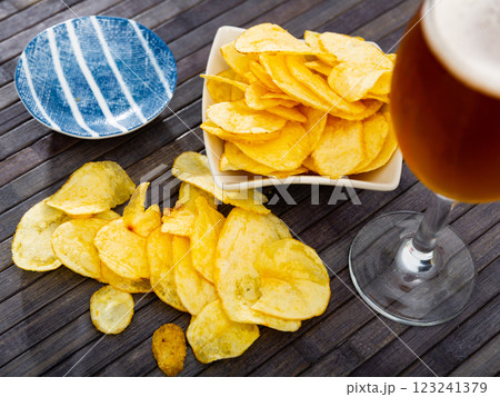 Potato chips and beer served on table 123241379