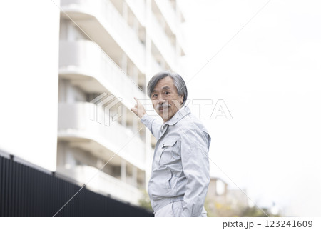マンションと作業服の男性 123241609