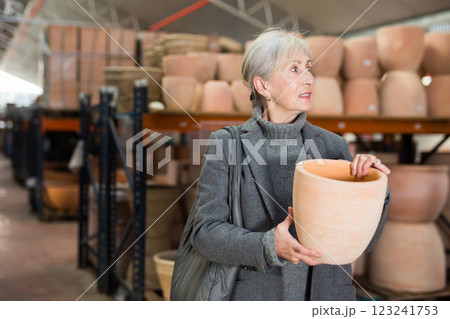 Elderly woman shopping in crockery store 123241753
