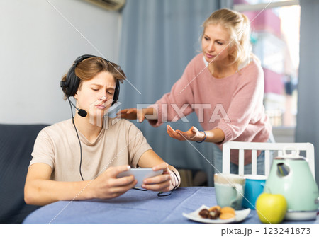 Mother asking for attention of her teenager son 123241873