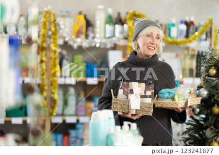 Elderly woman buyer chooses cosmetics gift set for christmas Elderly woman buyer chooses cosmetics gift set for christmas 123241877
