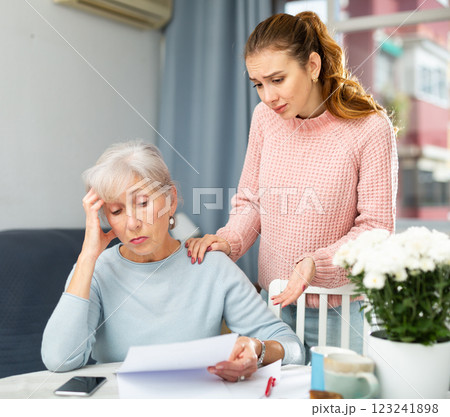 Upset mother and daughter with financial papers 123241898