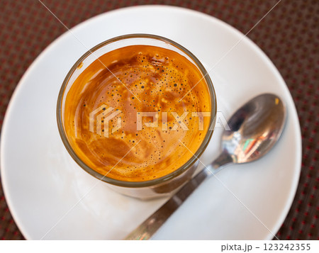 Freshly prepared cortado coffee in glass Freshly prepared cortado coffee in glass 123242355