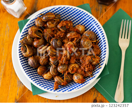 Shellfish snail cooked with minced meat and tomato dressing Shellfish snail cooked with minced meat and tomato dressing 123242357