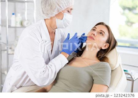 Young woman getting lip fillers. Young woman getting lip fillers. 123242376