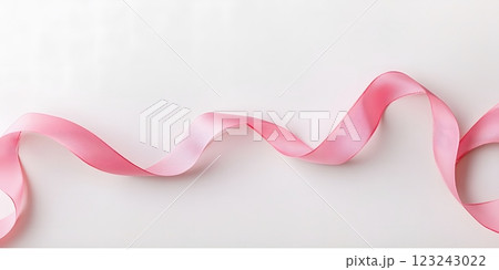 Gracefully curled pink ribbon positioned on a soft background, symbolizing the fight against breast cancer. Awareness concept 123243022